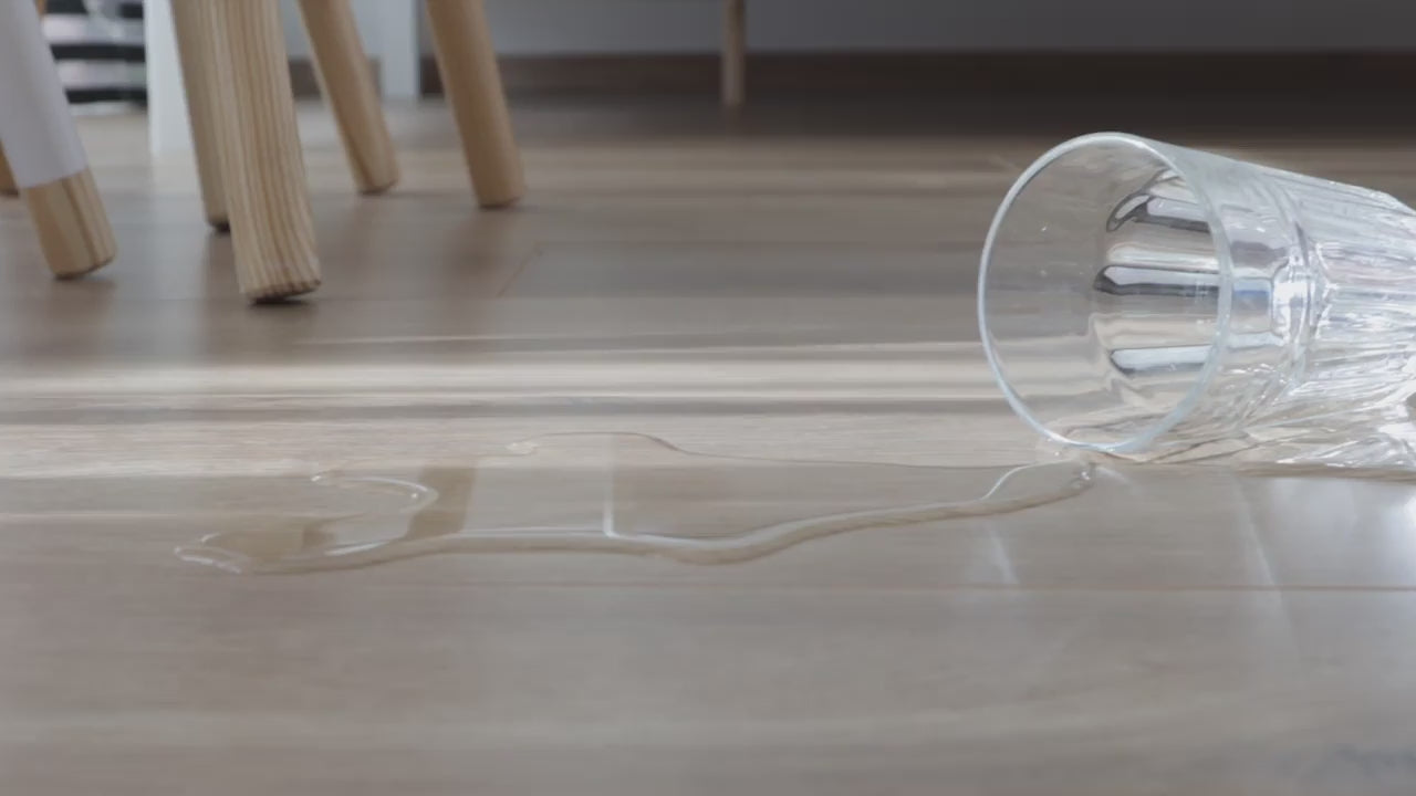 Video demonstrating EcoDense hybrid resilient flooring with liquid spilled on the surface to show waterproof performance